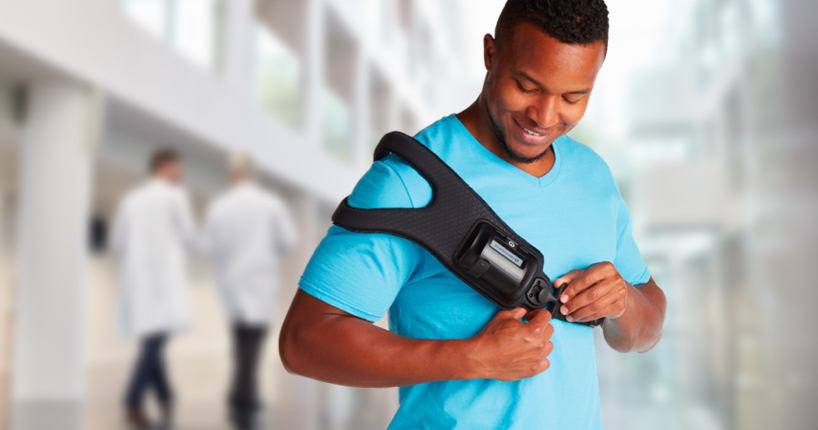 Man using a bone growth therapy device