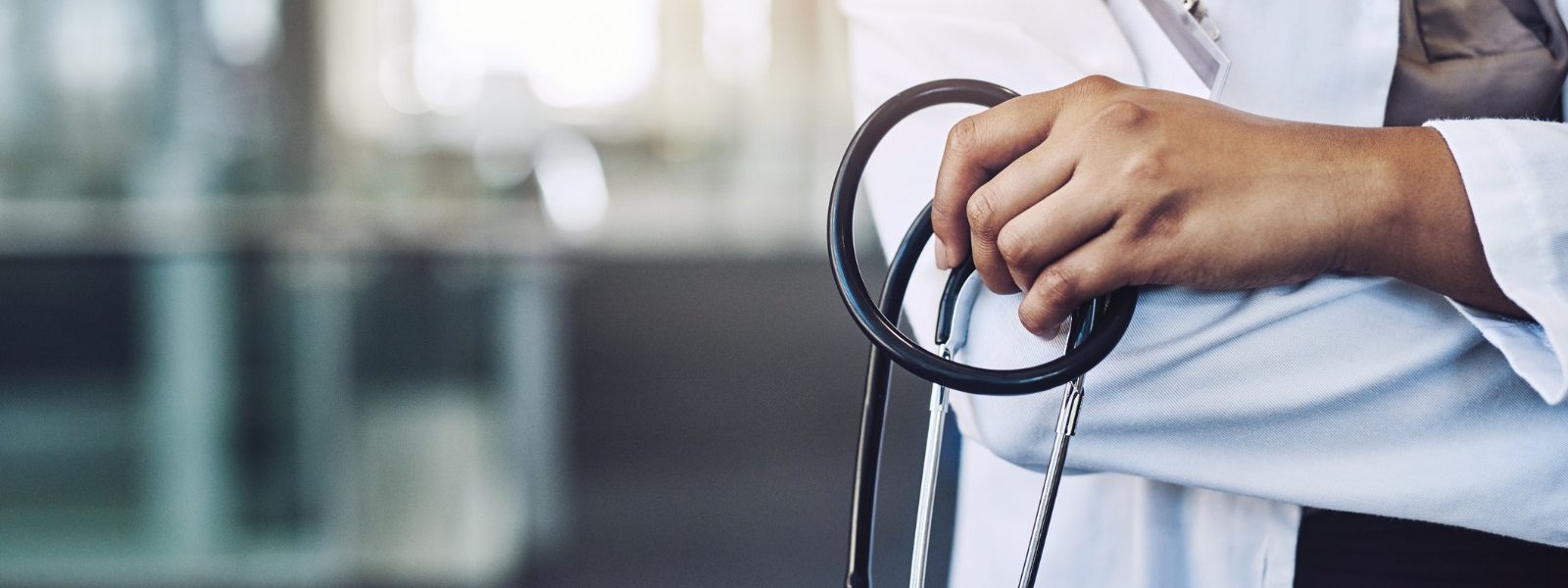 Doctors hand holding a stethoscope